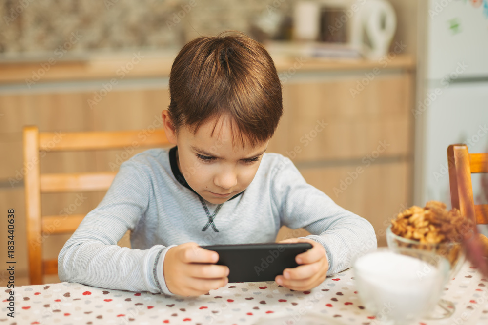 Little boy holding a phone in his hands Little boy holding a phone in his hands