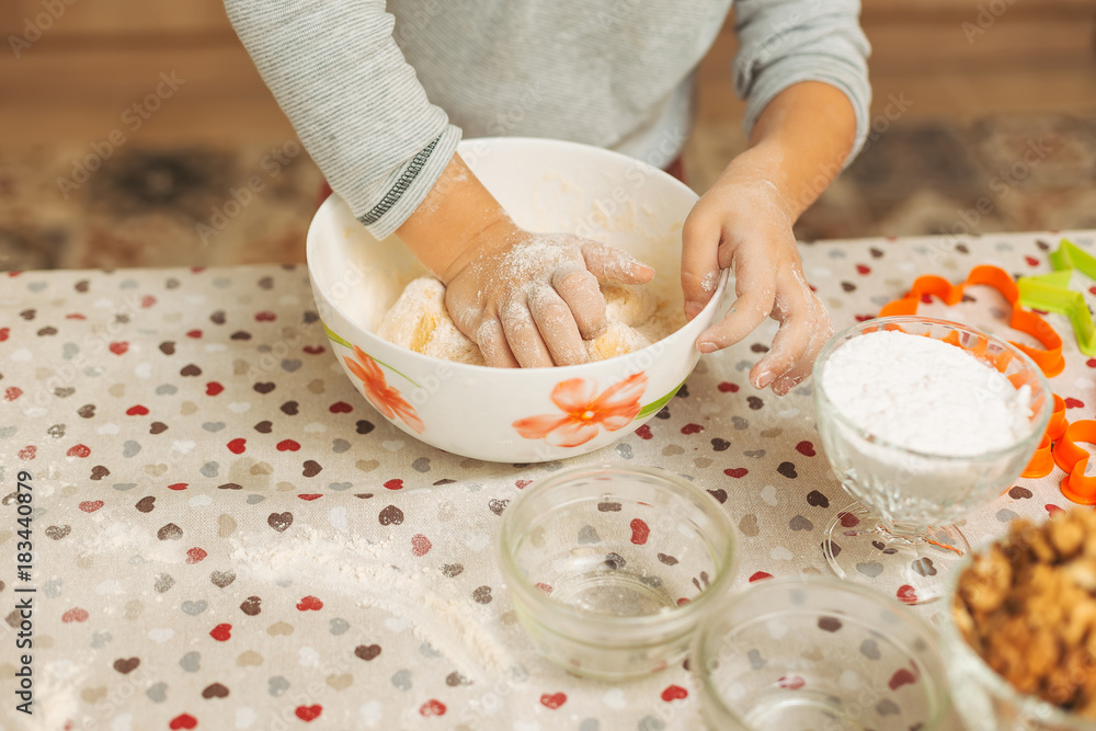 Close-up child hands making dough for biscuits Close-up child hands making dough for biscuits