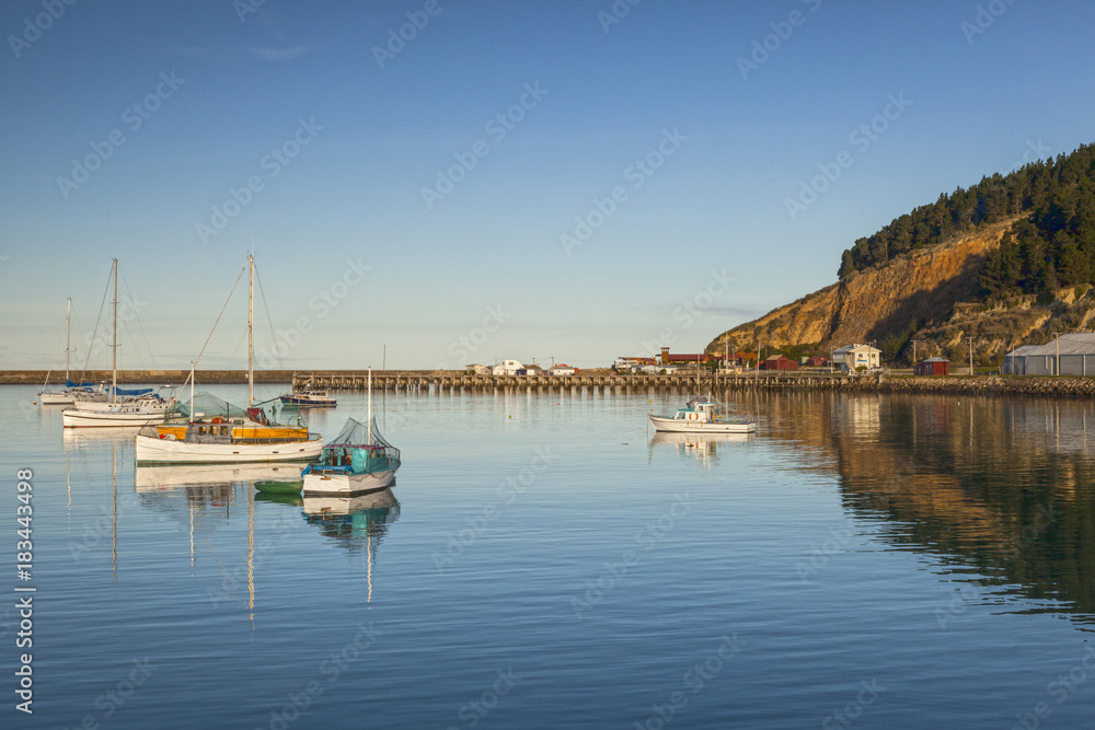 Boats in Oamaru Harbour, Otago, New Zealand.