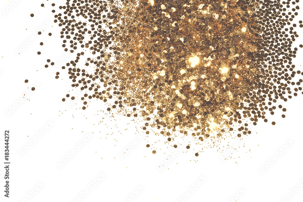 Textured background with golden glitter sparkle on white, decorative spangles in nostalgic colors Textured background with golden glitter sparkle on white, decorative spangles in nostalgic colors