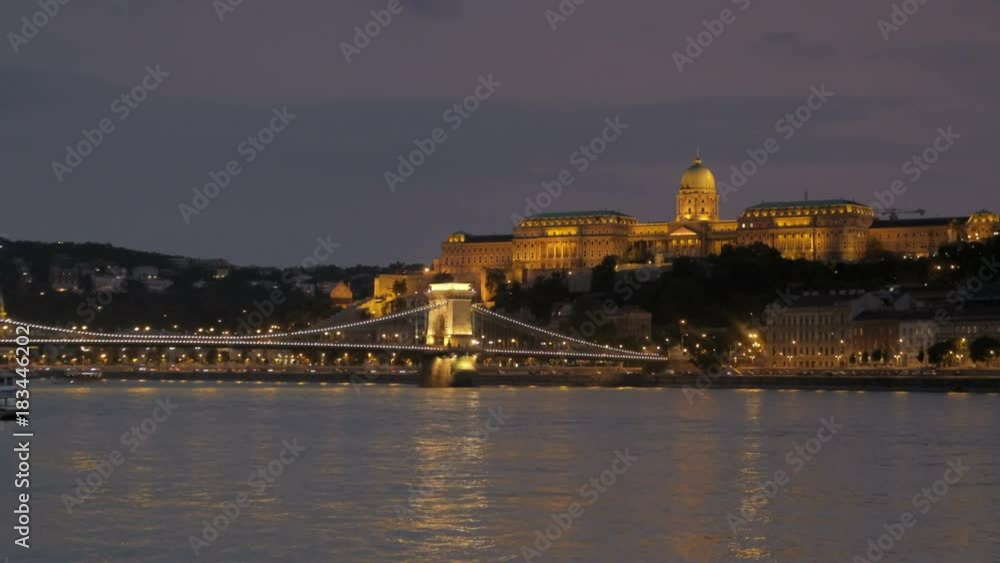 Static twilight shot of Budapest Castle and Chain Bridge lit up at night Static twilight shot of Budapest Castle and Chain Bridge lit up at night