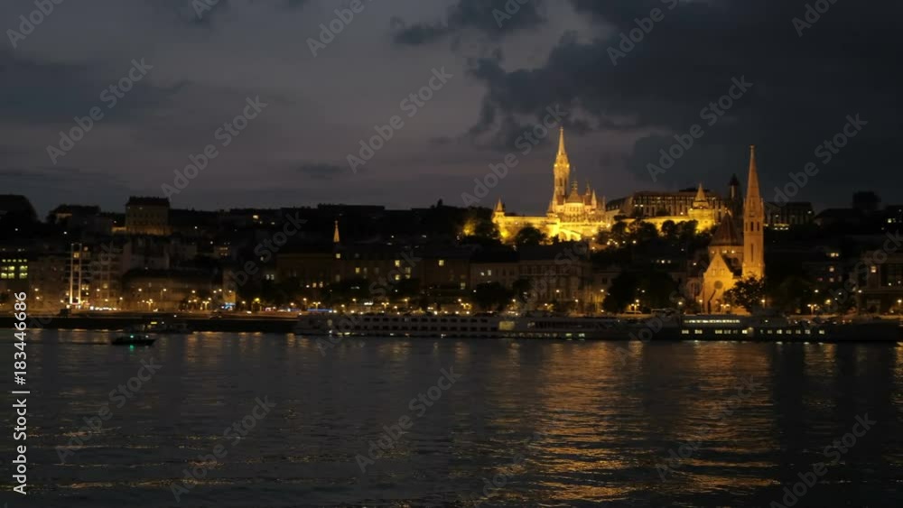 Slow pan across Danube River at night. From Matthias Church to Buda Castle and chain Bridge in Budapest Slow pan across Danube River at night. From Matthias Church to Buda Castle and chain Bridge in Budapest