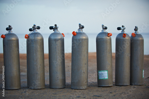 Collection of grey scuba diving air oxygen tanks.