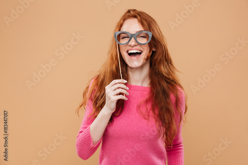 Portrait of a cheerful pretty redhead girl