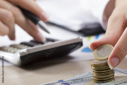 Money, Financial, Business Growth concept, Savings, close up of female hand stacking golden coins