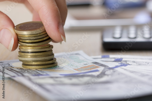 Money, Financial, Business Growth concept, Savings, close up of female hand stacking golden coins photo