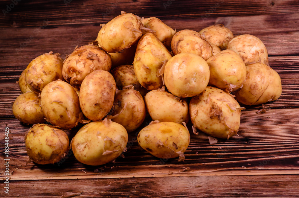 Pile of the young potato on wooden table Pile of the young potato on wooden table