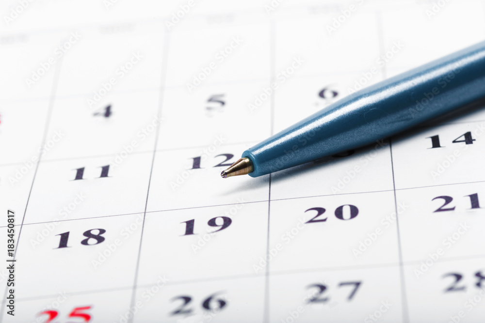 Check out the dates in a business calendar concept Check out the dates in a business calendar concept