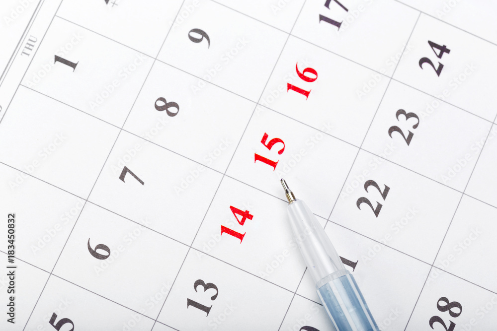 Check out the dates in a business calendar concept Check out the dates in a business calendar concept
