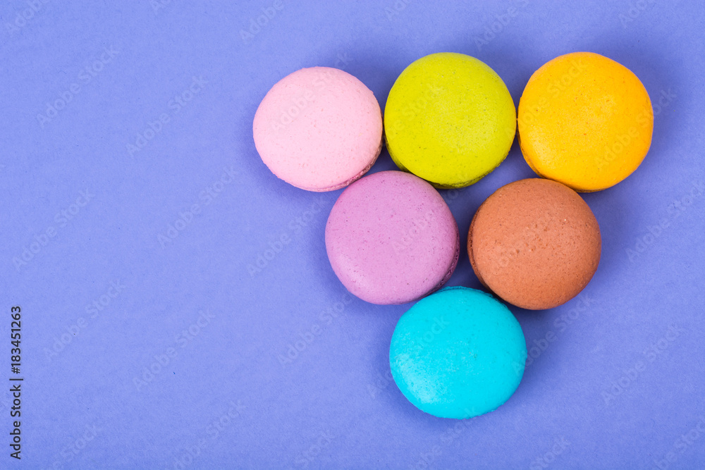 Small French macaroons on pastel background Small French macaroons on pastel background