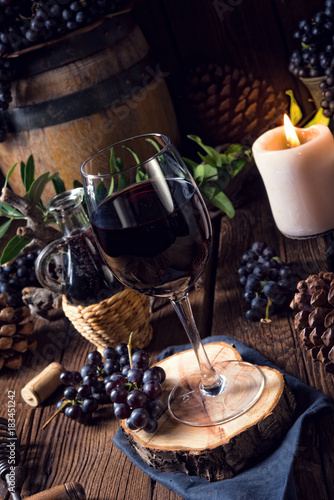 Fototapeta Naklejka Na Ścianę i Meble -  Red wine from a barrel with grapes and a glass of wine