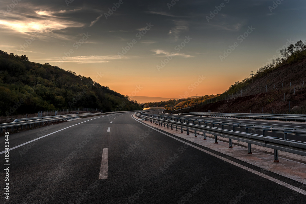 Empty Highway with markings at sunset