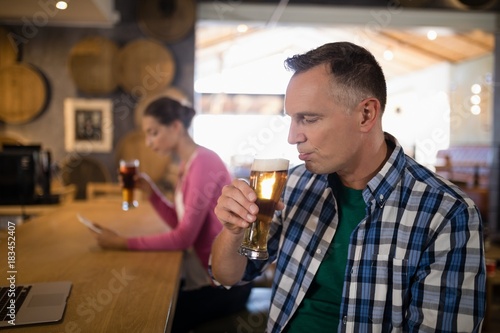 Man having beer at counter