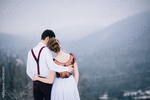 walk the groom and the bride in the Carpathian mountains
