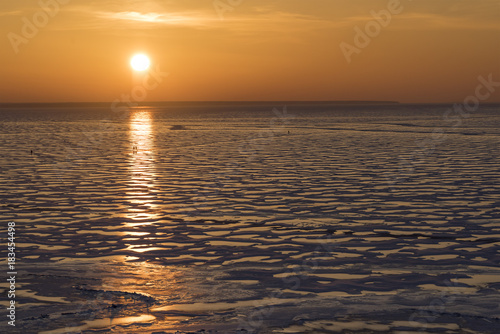 Winter nature landscape. Sunset over the frozen Ob sea.