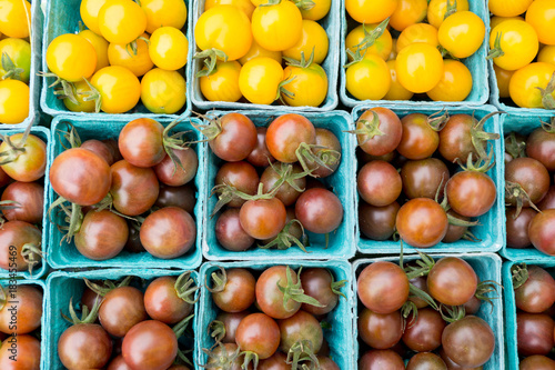 Organic black and yellow cherry tomatoes at a Farmer s Market