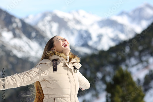 Excited woman laughing in the mountain