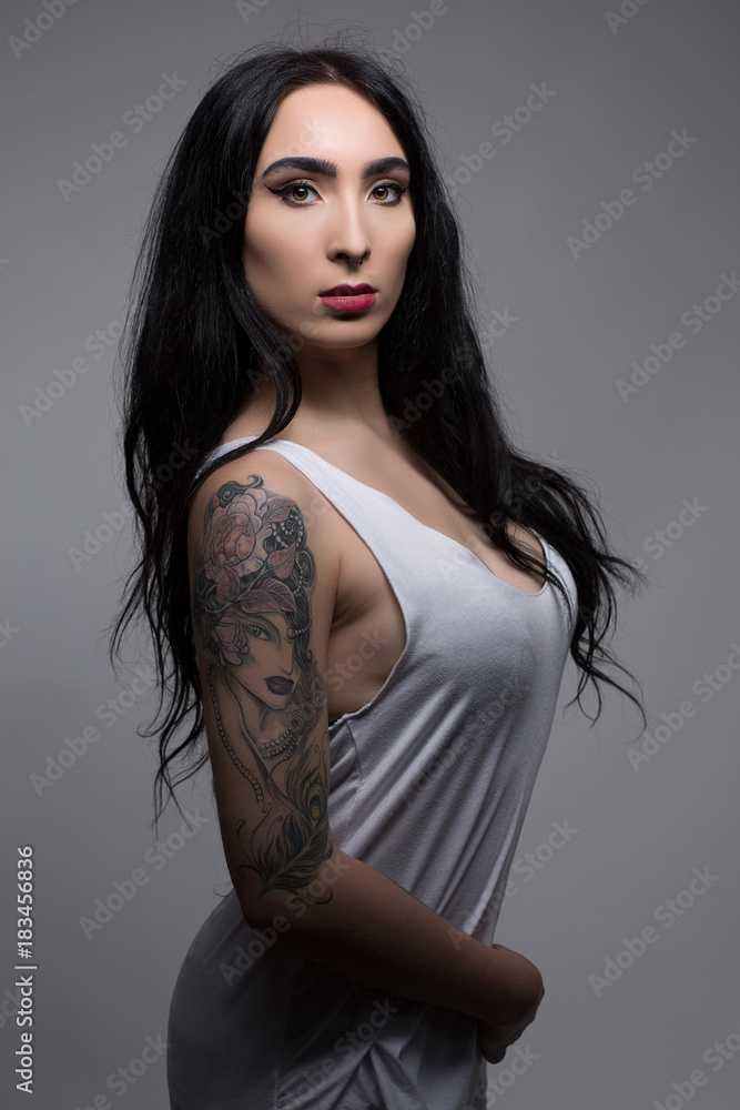 attractive sexy tattoo girl in white sweat shirt Stock Photo | Adobe Stock