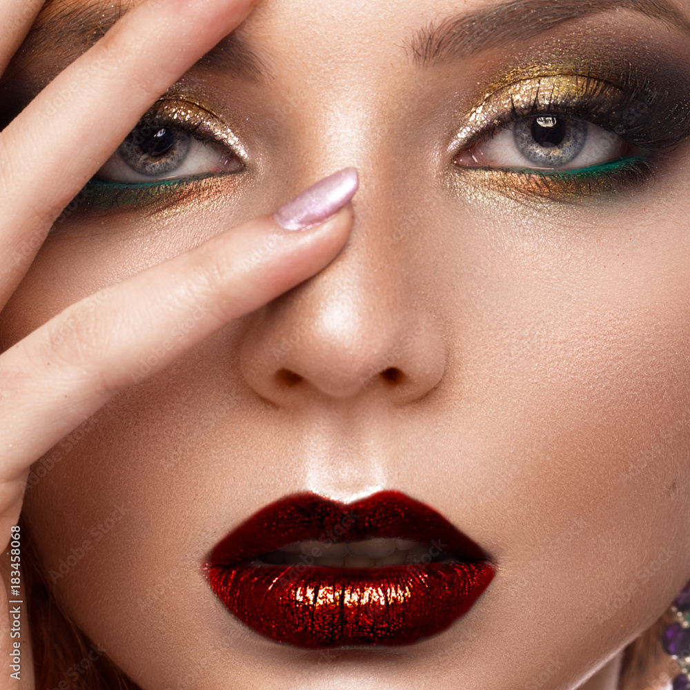 Naklejka premium Beautiful redhair model: curls, bright makeup, jewelry and red lips. The beauty face.