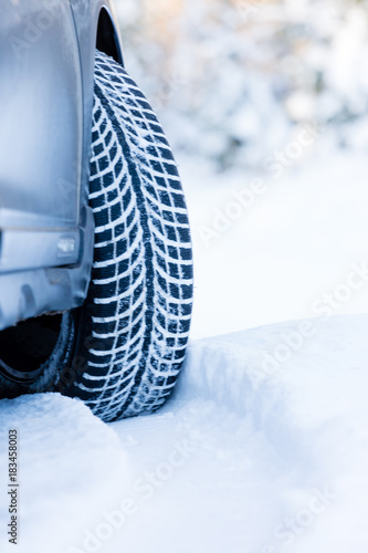 Winter tire. Closeup on SUV tire in snowy winter conditions.