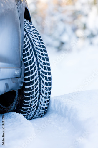 Winter tire. Closeup on SUV tire in snowy winter conditions.