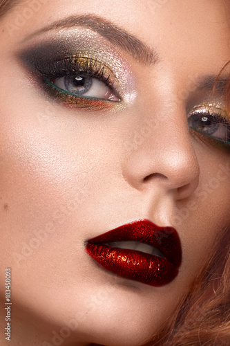 Beautiful redhair model: curls, bright makeup, jewelry and red lips. The beauty face.