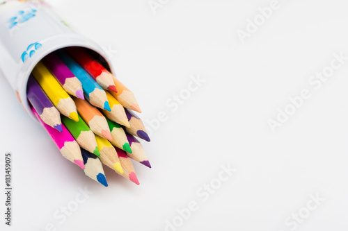 Colored pencils in pencile case on white background photo