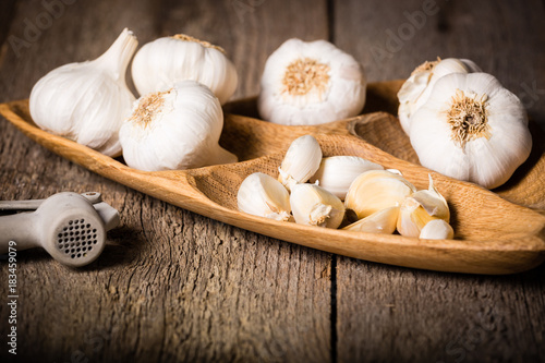Garlic, Garlic cloves and Garlic bulb in vintage handmade wooden bowl.