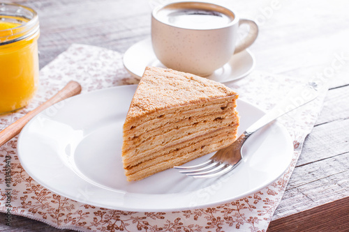Homemade honey cake on white wooden table