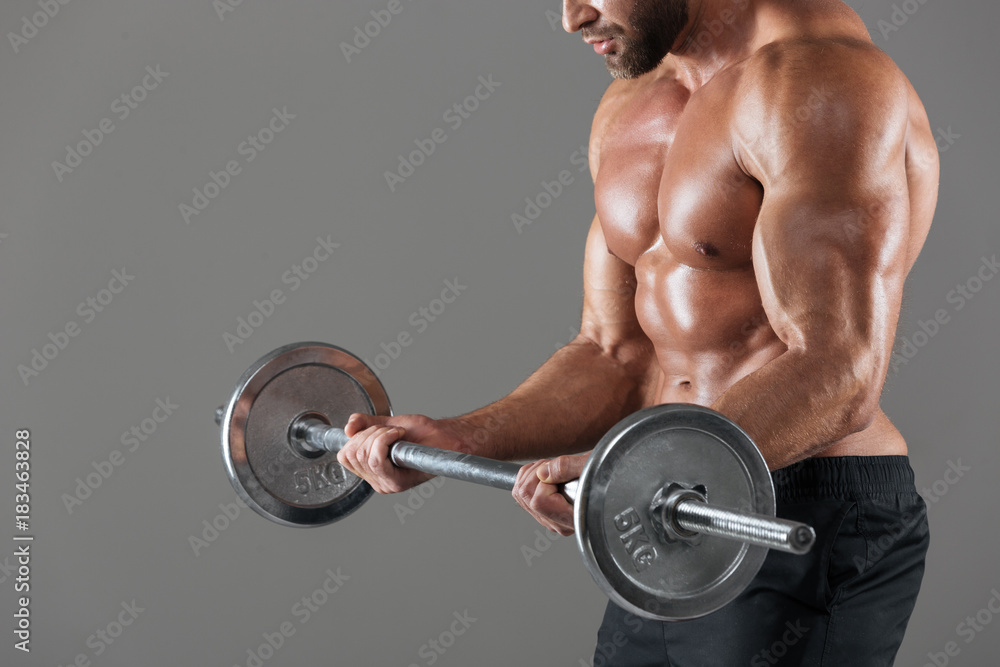 Side view cropped image of a strong shirtless male bodybuilder Side view cropped image of a strong shirtless male bodybuilder