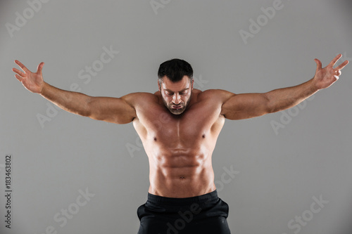 Portrait of a concentrated strong shirtless male bodybuilder