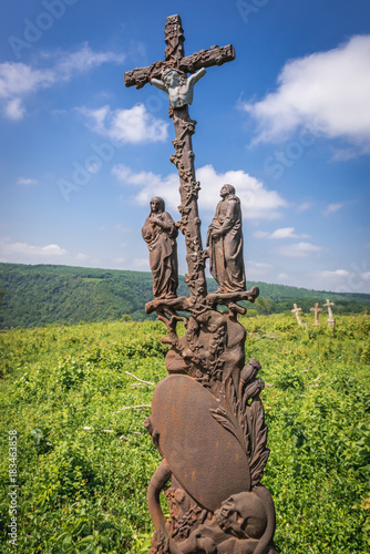 Old grave on abandoned Catholic cemetery near Chervonohorod Castle ruins in Ukraine photo