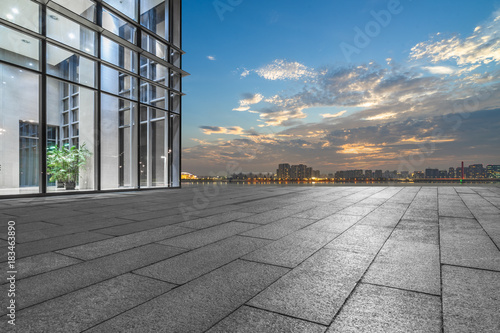 night view of empty brick floor front of modern building