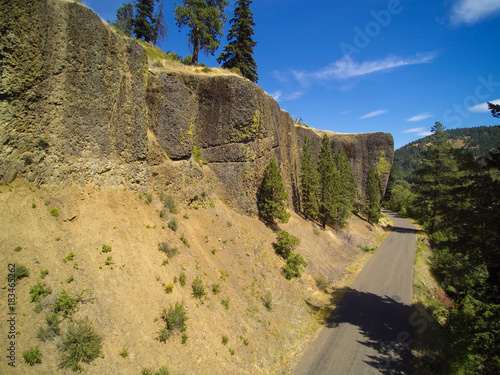 Empty cliff road running through mountains photo