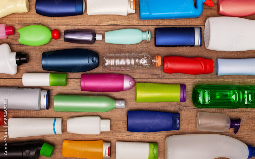 Colorful plastic bottles on wooden surface Colorful plastic bottles on wooden surface