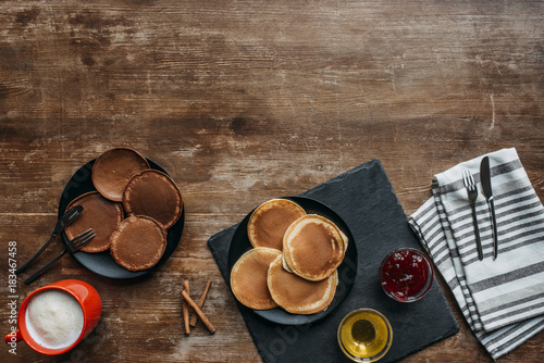 top view of tasty breakfast with pancakes and coffee on wooden table