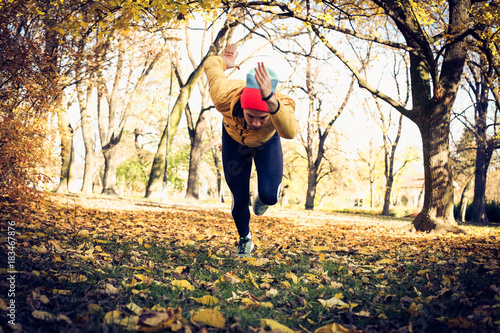 Man in park, running. Autumn season.