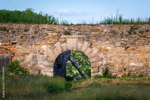 One of the gates of ruined castle in Mykulyntsi village, Ukraine photo