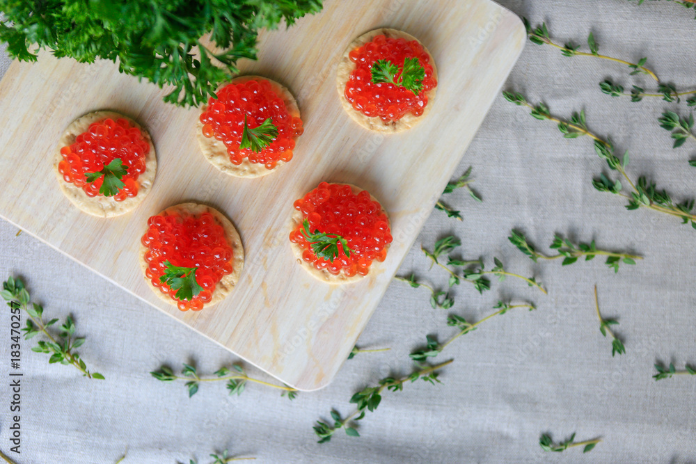Closeup of red caviar appetizer served on crackers Closeup of red caviar appetizer served on crackers