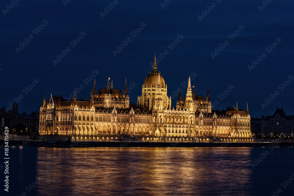Fototapeta premium Budapest Parliament building and Danube river at night with illumination, travel sightseeing background