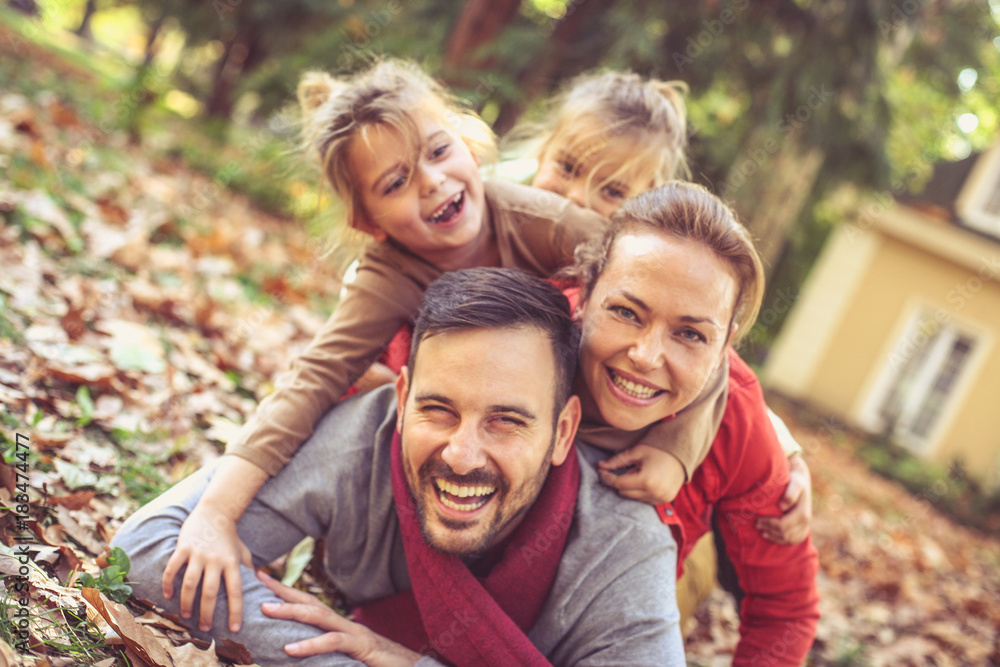 Fototapeta premium Happy family Laying on ground , poses to camera.