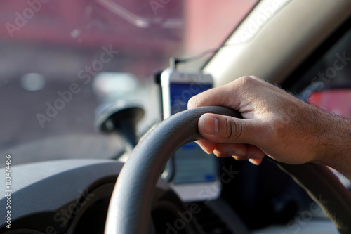  Closeup male hand hold car steering wheel. Man driving car concept.
