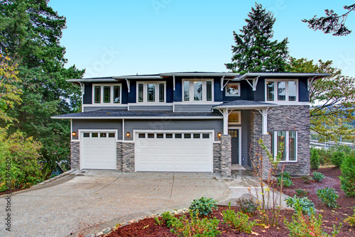 Luxury new construction home with stone veneer siding. photo