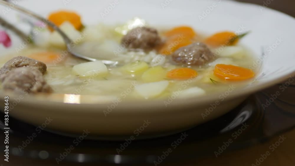 A Man Eats A Spoon Of Soup From A Plate A Man Eats A Spoon Of Soup From A Plate