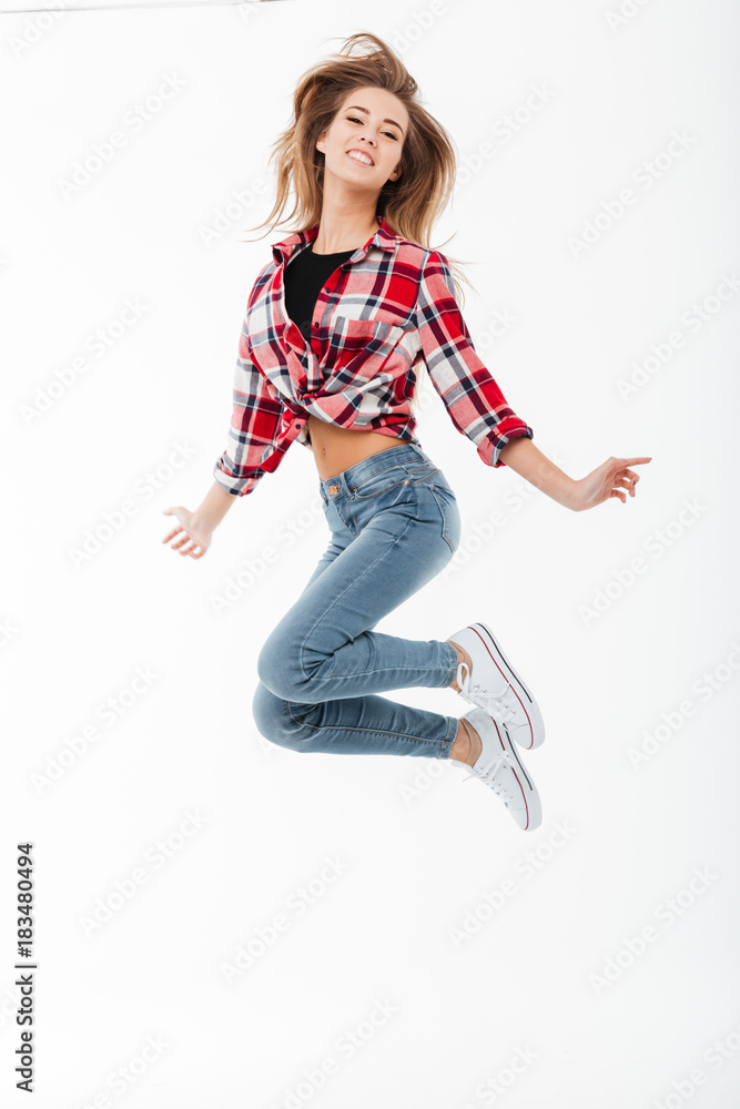 Full length portrait of a cheerful pretty girl in shirt