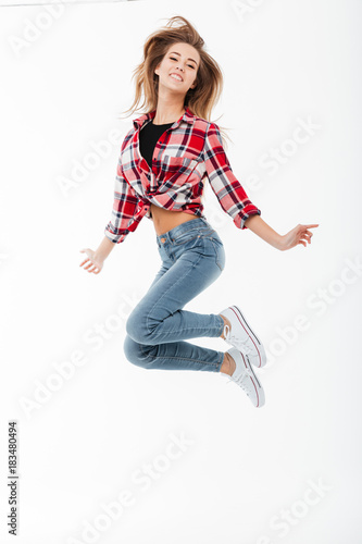 Full length portrait of a cheerful pretty girl in shirt