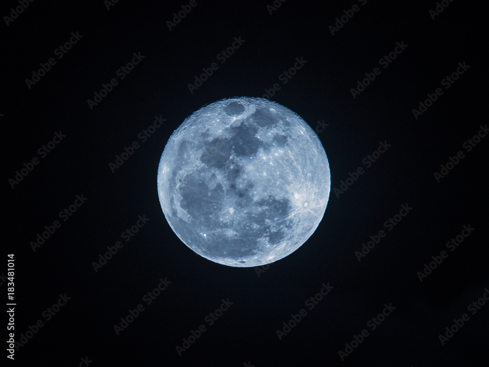 A full moon in the night sky tinted blue (tungsten), December 2017, Thailand A full moon in the night sky tinted blue (tungsten), December 2017, Thailand