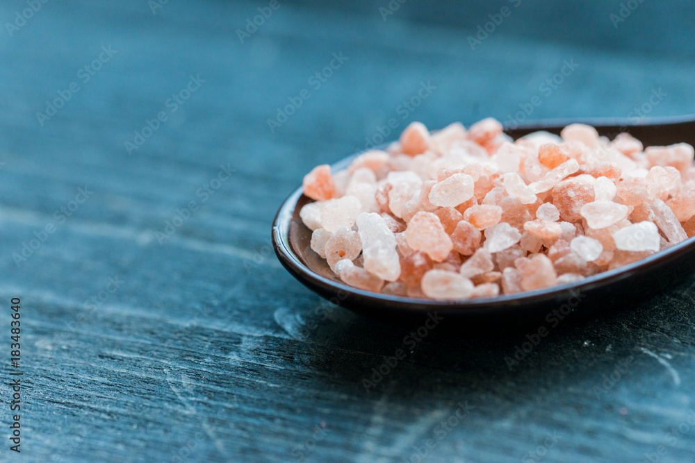 Studio shot of spoon with rough pink salt Studio shot of spoon with rough pink salt