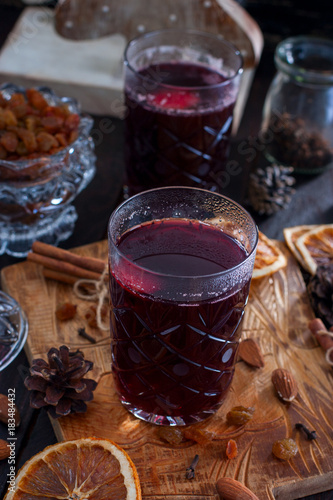 Scandinavian hot alcoholic drink with cinnamon in a glass cup on a wooden board, selective focus photo