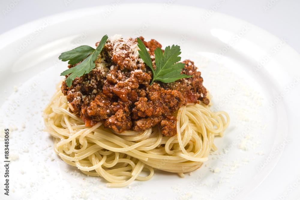 Italian spaghetti pasta with beef and tomato sauce bolognese on white plate Italian spaghetti pasta with beef and tomato sauce bolognese on white plate